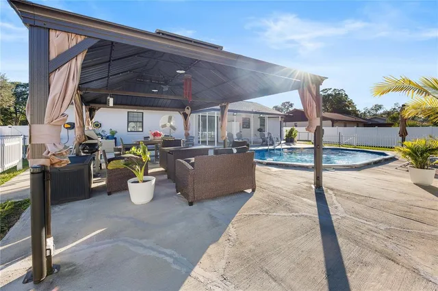 a view of a patio with table and chairs potted plants