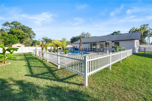 a view of a house with a yard and plants