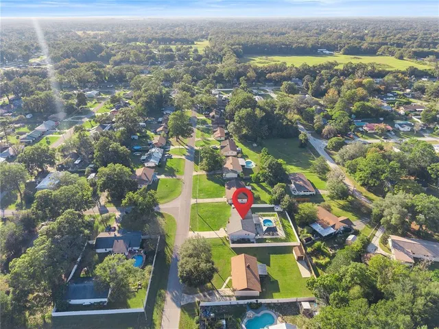 an aerial view of residential house and outdoor space