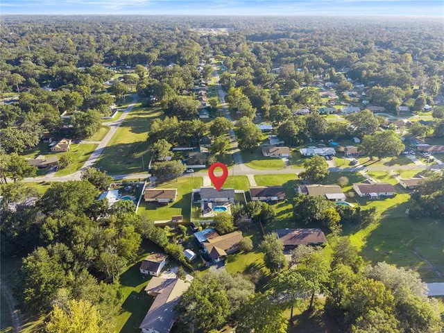 an aerial view of residential houses with outdoor space and swimming pool