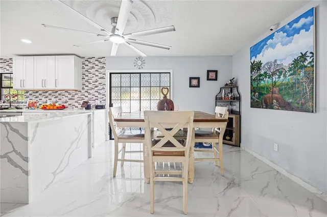 a view of a dining room with furniture and a large window