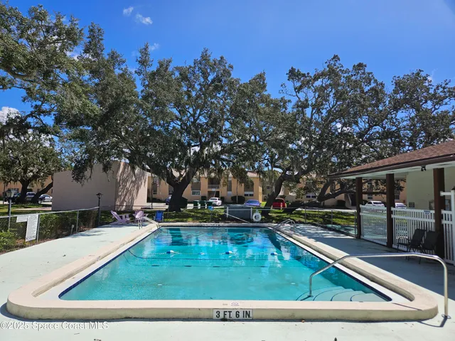 a view of a house with a backyard and sitting area