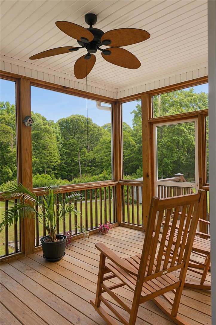 190 Fred Bradford Road Iva, SC 29655 - Photo 14 of 32 Enjoy tranquil views from this spacious screened-in porch, perfect for peaceful outdoor living.