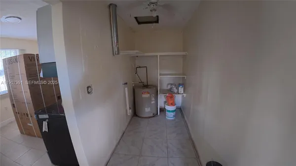 a view of storage and utility room with a refrigerator