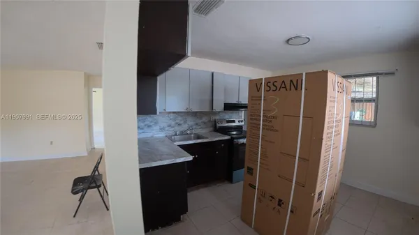 a kitchen with a refrigerator and a sink