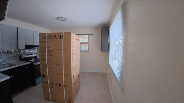 a kitchen with a refrigerator and a sink