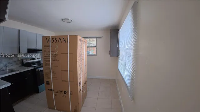 a kitchen with a refrigerator and a sink