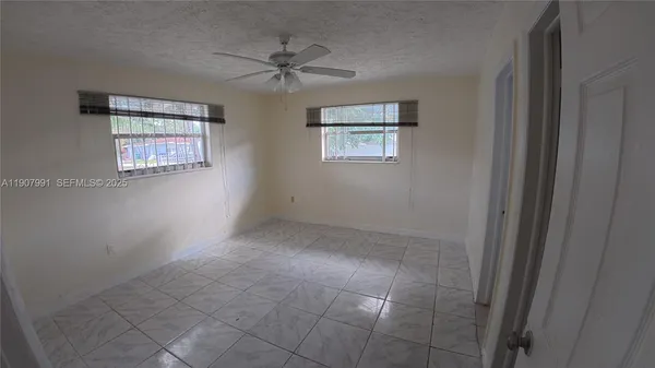 a room with a window and a rug