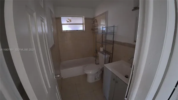 a bathroom with a bathtub and toilet