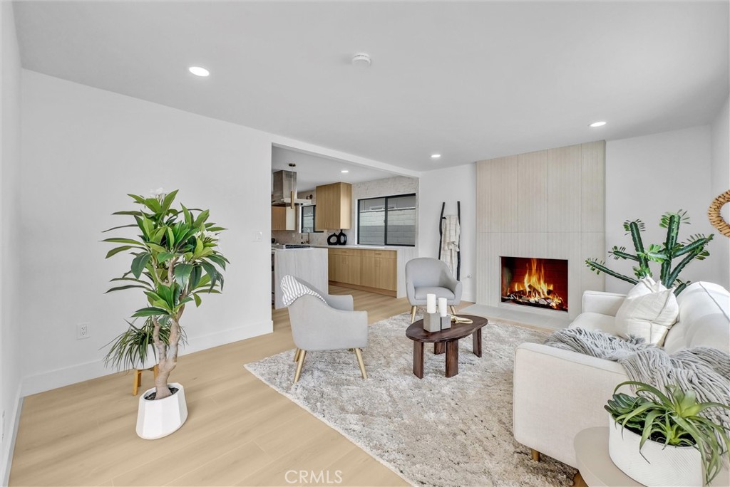 13682 Carroll Way Tustin, CA 92780 - Photo 25 of 51 a living room with furniture a potted plant and a fireplace