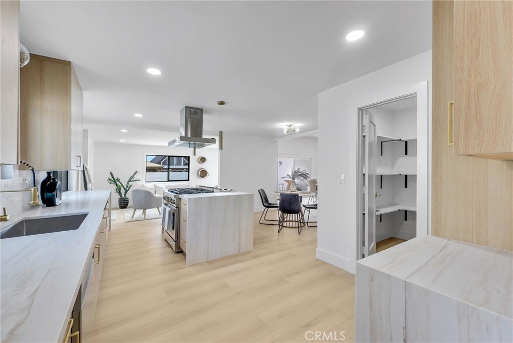 13682 Carroll Way Tustin, CA 92780 - Photo 26 of 51 a living room with furniture a fireplace and a kitchen view