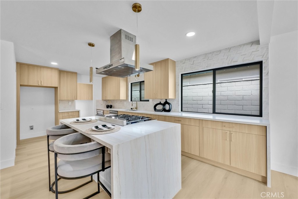 13682 Carroll Way Tustin, CA 92780 - Photo 28 of 51 a kitchen with stainless steel appliances a stove a table and chairs in it