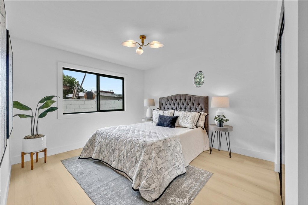 13682 Carroll Way Tustin, CA 92780 - Photo 31 of 51 a bedroom with a bed and a chandelier