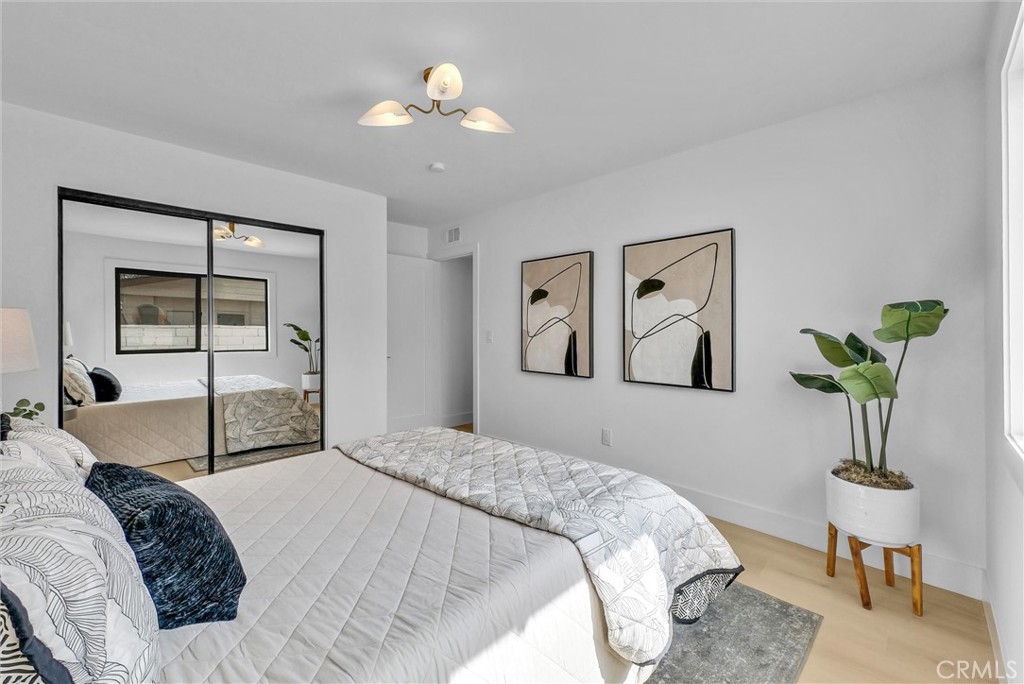 13682 Carroll Way Tustin, CA 92780 - Photo 32 of 51 a bedroom with a bed and a chandelier