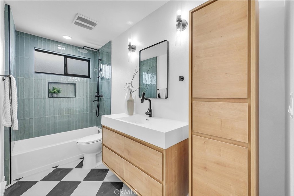 13682 Carroll Way Tustin, CA 92780 - Photo 33 of 51 a bathroom with a sink a toilet a shower and a mirror