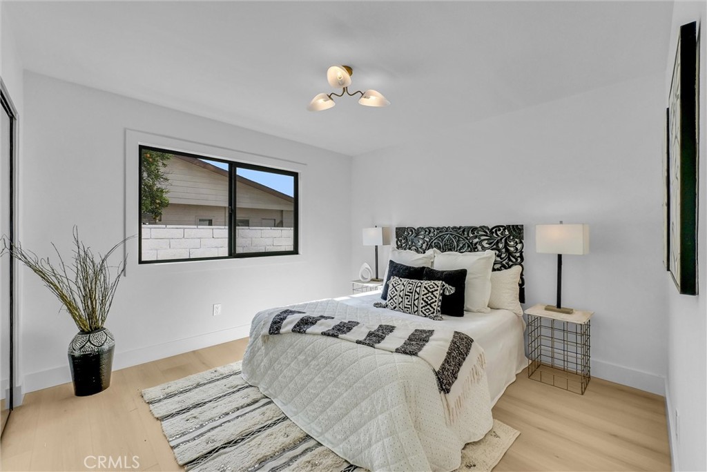 13682 Carroll Way Tustin, CA 92780 - Photo 34 of 51 a bedroom with a large bed and a potted plant