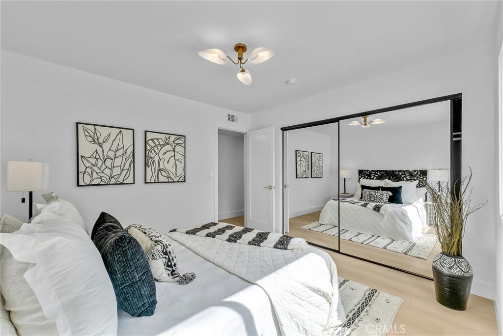 13682 Carroll Way Tustin, CA 92780 - Photo 35 of 51 a bedroom with a bed and a chandelier