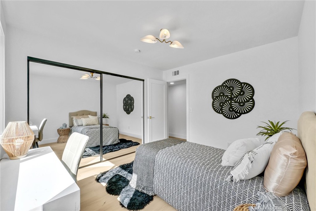 13682 Carroll Way Tustin, CA 92780 - Photo 37 of 51 a bedroom with a bed and a chandelier