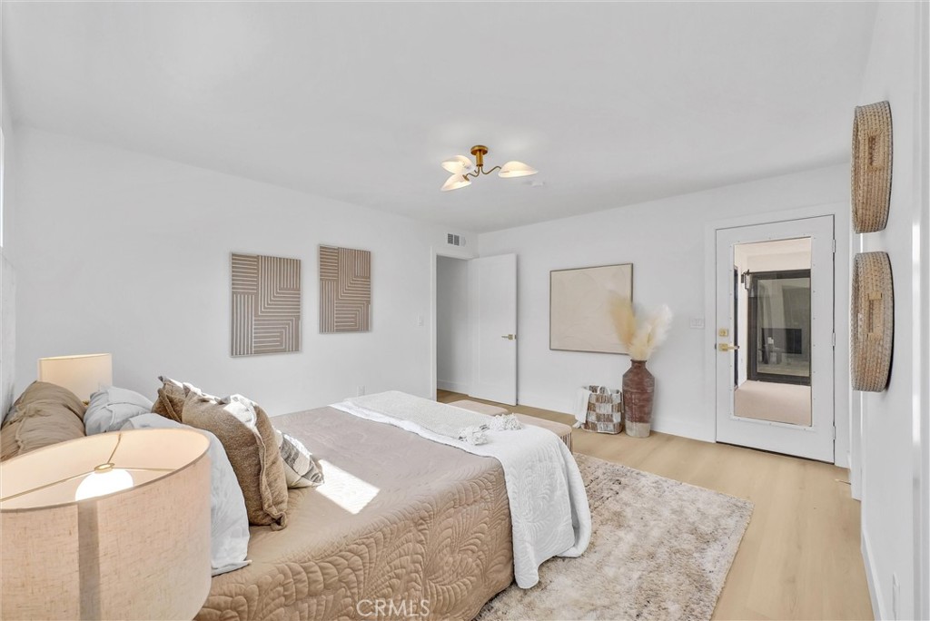 13682 Carroll Way Tustin, CA 92780 - Photo 39 of 51 a spacious bedroom with a bed and wooden floor