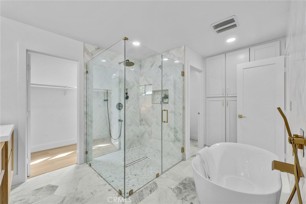 13682 Carroll Way Tustin, CA 92780 - Photo 40 of 51 a bathroom with a bathtub and a shower