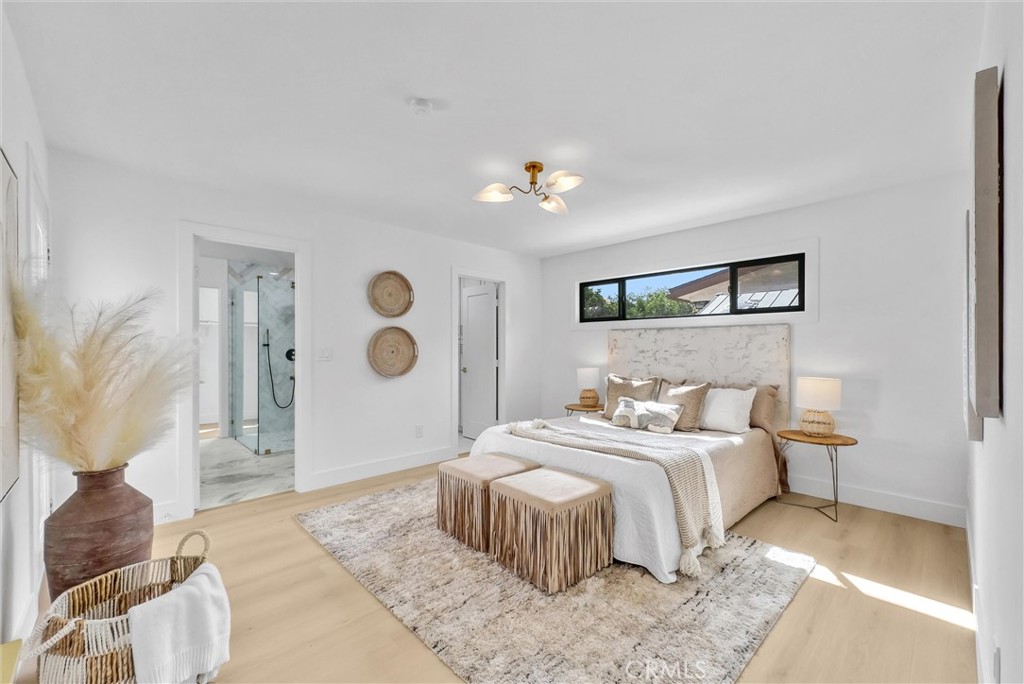 13682 Carroll Way Tustin, CA 92780 - Photo 4 of 51 a bedroom with a large bed and a chandelier