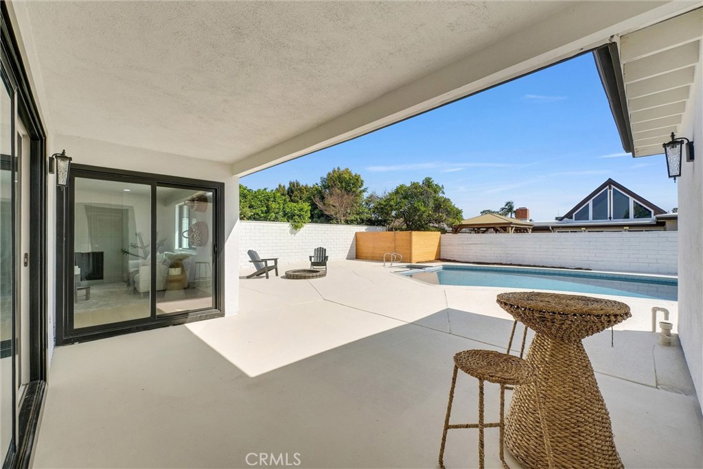13682 Carroll Way Tustin, CA 92780 - Photo 43 of 51 a living room with furniture and a floor to ceiling window
