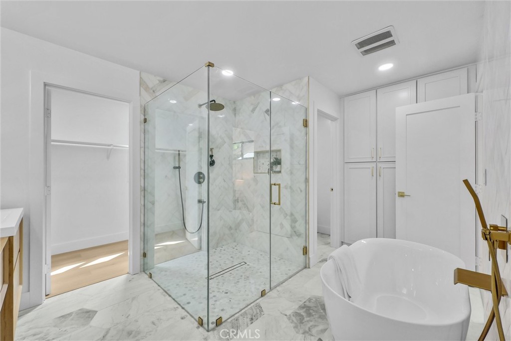 13682 Carroll Way Tustin, CA 92780 - Photo 5 of 51 a bathroom with a bathtub and a shower