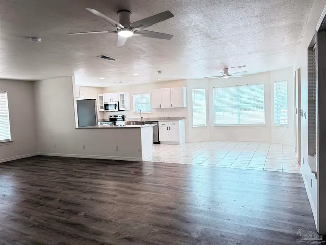 a kitchen with granite countertop cabinets and window