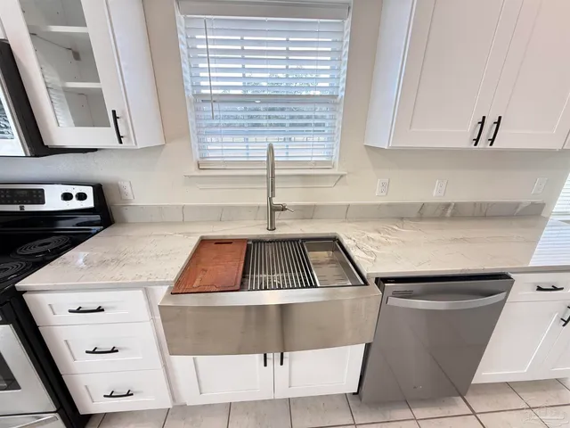 a kitchen with stainless steel appliances a stove microwave and sink