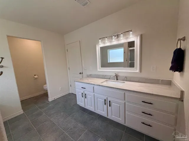 an empty room with a ceiling fan and a window