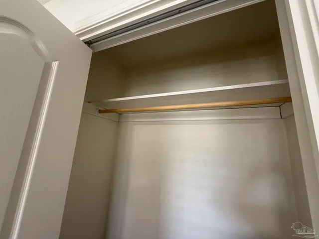 a bathroom with a granite countertop sink a toilet a mirror and shower