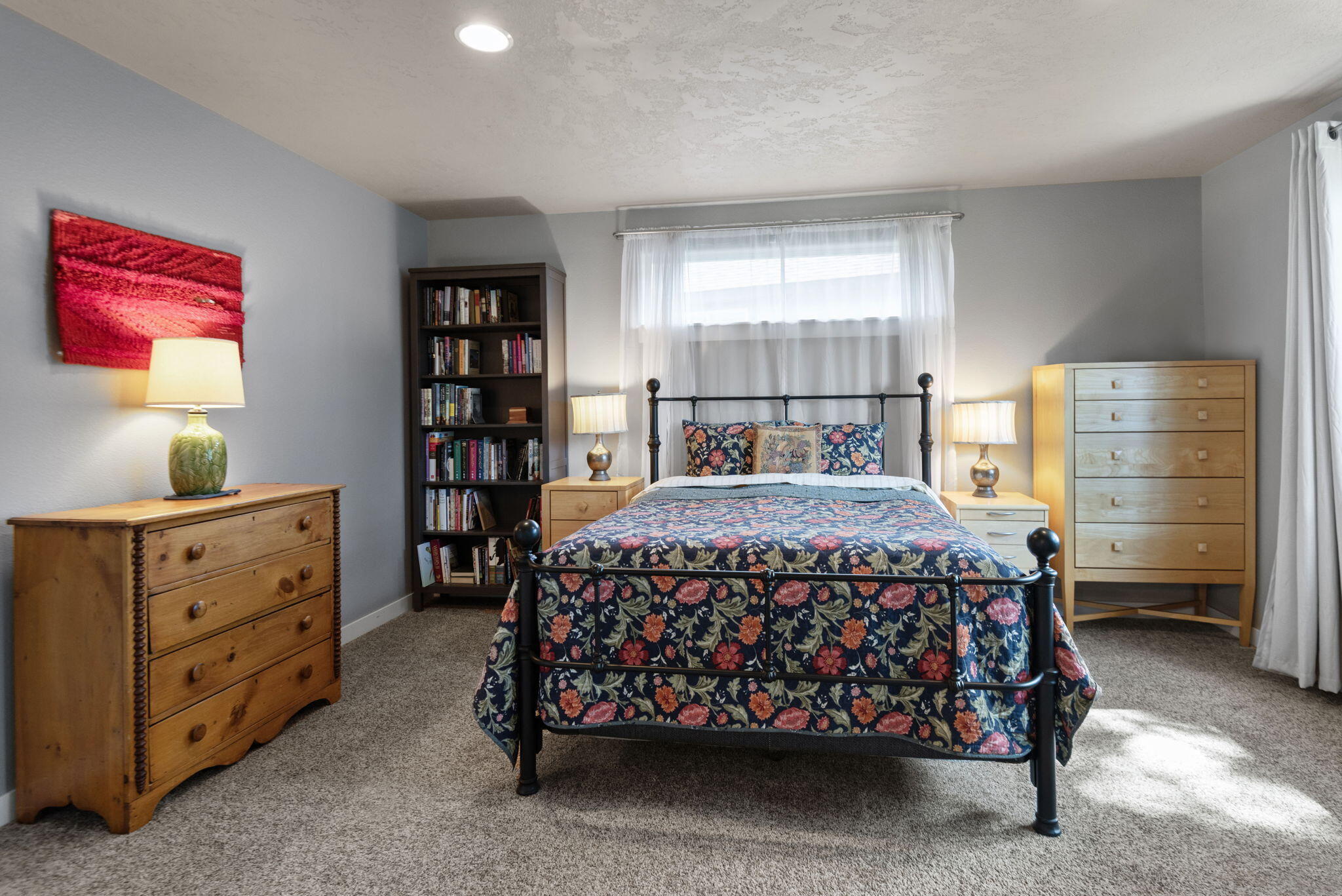715 Brooks Camp Road Sisters, OR 97759 - Photo 13 of 25 a bed sitting in a bedroom next to a window and dresser