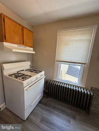 a stove top oven sitting inside of a kitchen