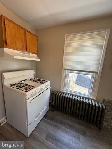 a stove top oven sitting inside of a kitchen