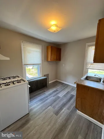 a view of kitchen with sink and refrigerator