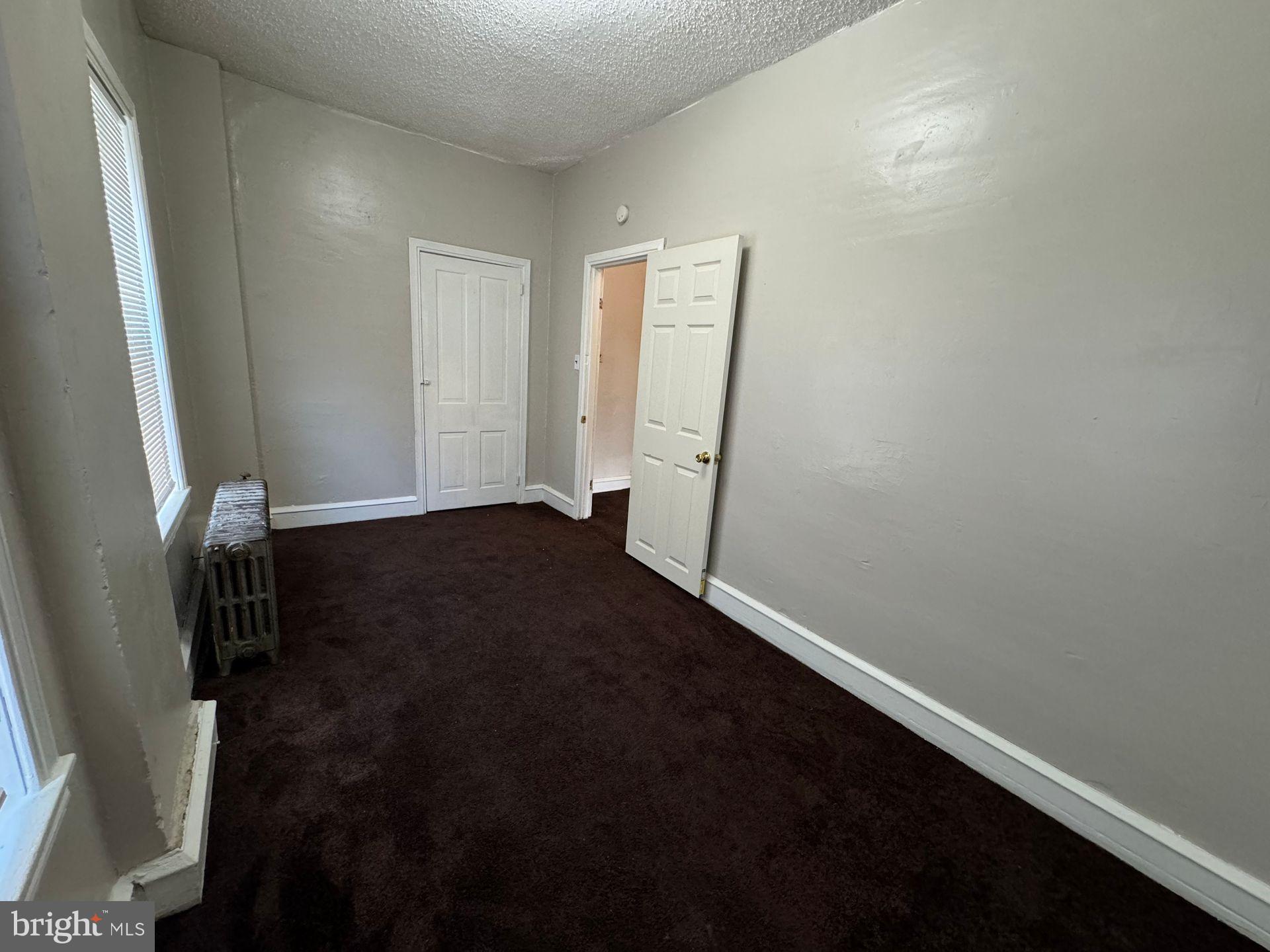 2106 West 4th Street, Unit 2 Chester, PA 19013 - Photo 4 of 5 an empty room with a door