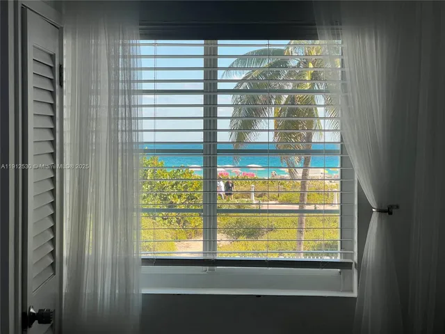 a view of a glass door with a tree