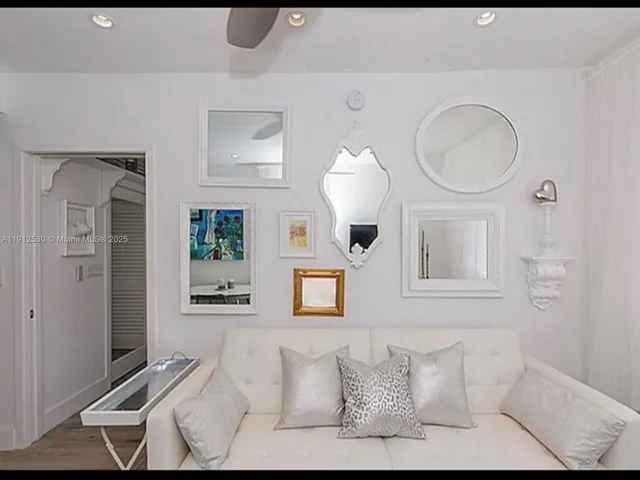 a living room with furniture a mirror and a window