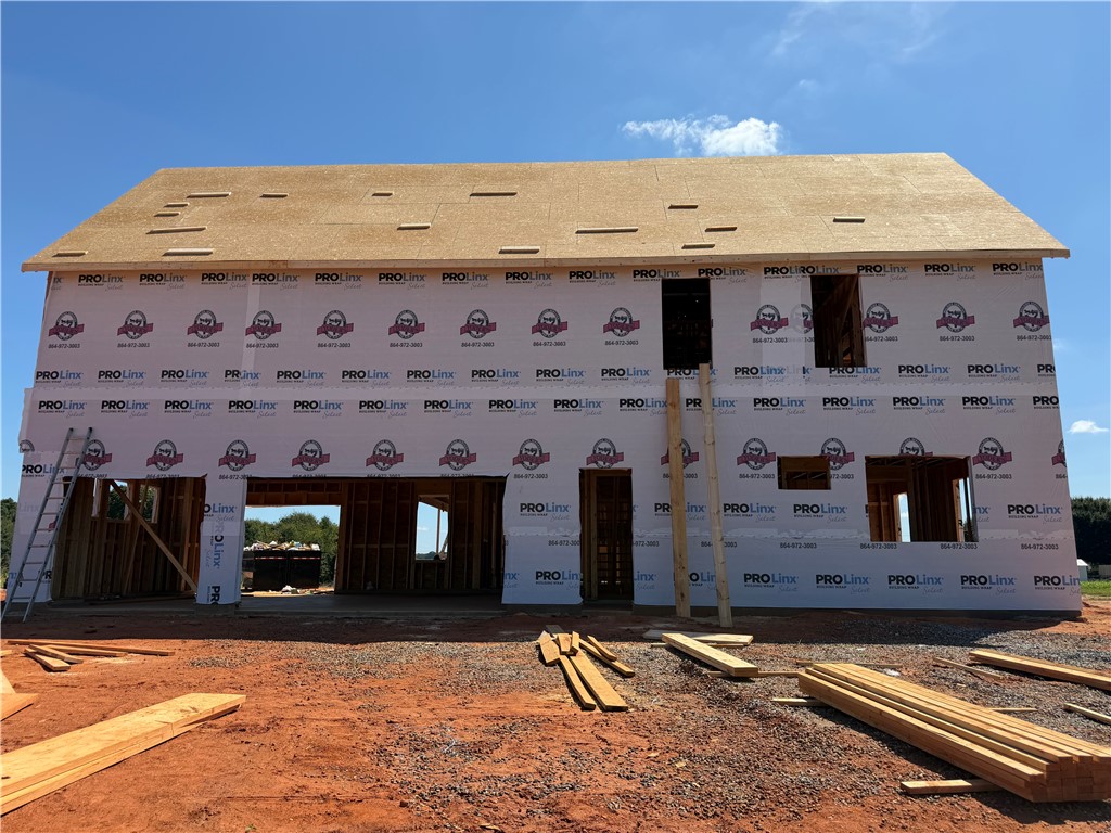 113 Dorchester Road Belton, SC 29627 - Photo 12 of 12 A new residential structure takes shape on a spacious lot under a clear blue sky.