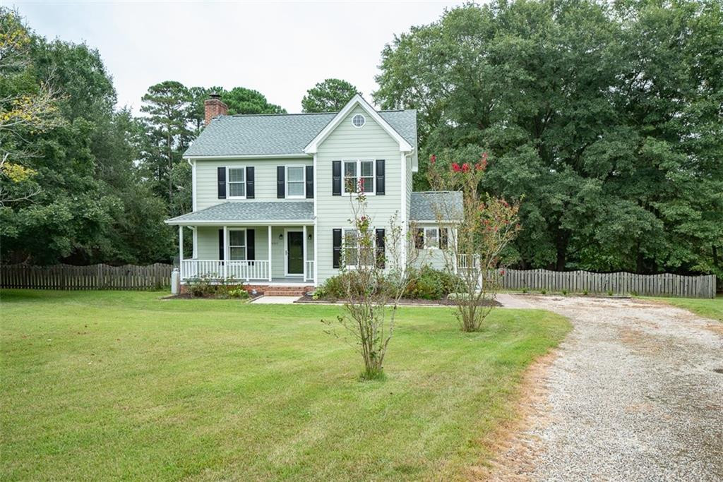 9317 Meadow Rue Place Raleigh, NC 27603 - Photo 1 of 36 a front view of a house with a garden