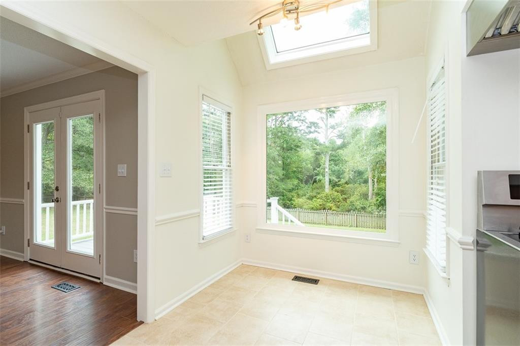 9317 Meadow Rue Place Raleigh, NC 27603 - Photo 15 of 36 a view of an empty room with wooden floor and a window