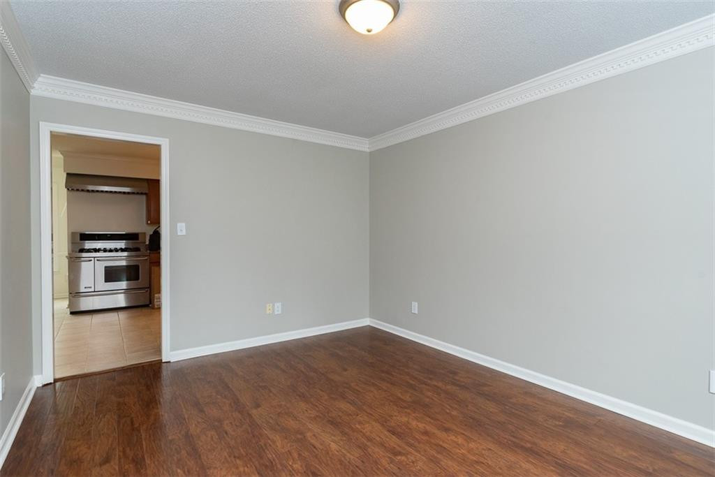 9317 Meadow Rue Place Raleigh, NC 27603 - Photo 17 of 36 a view of empty room with wooden floor
