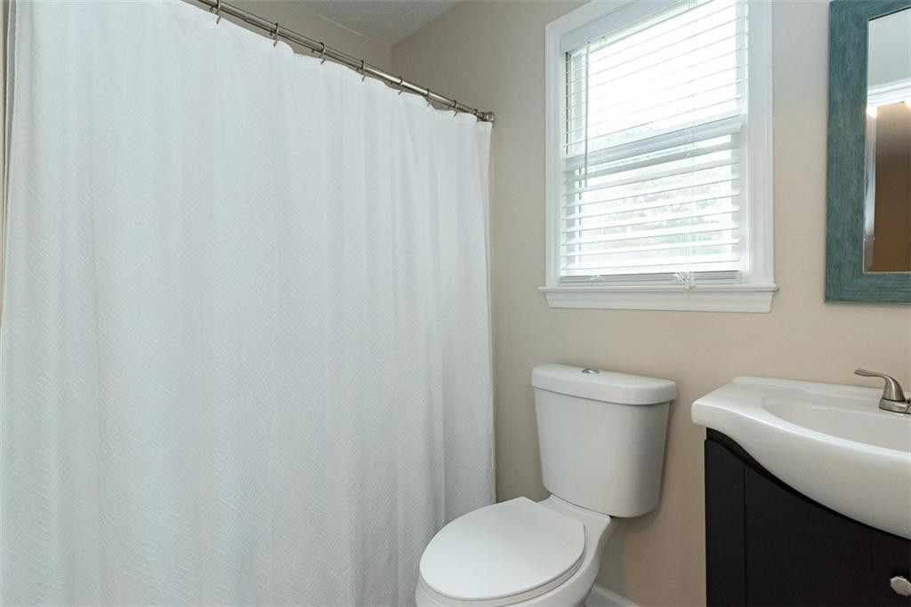 9317 Meadow Rue Place Raleigh, NC 27603 - Photo 21 of 36 a white toilet sitting next to a white sink