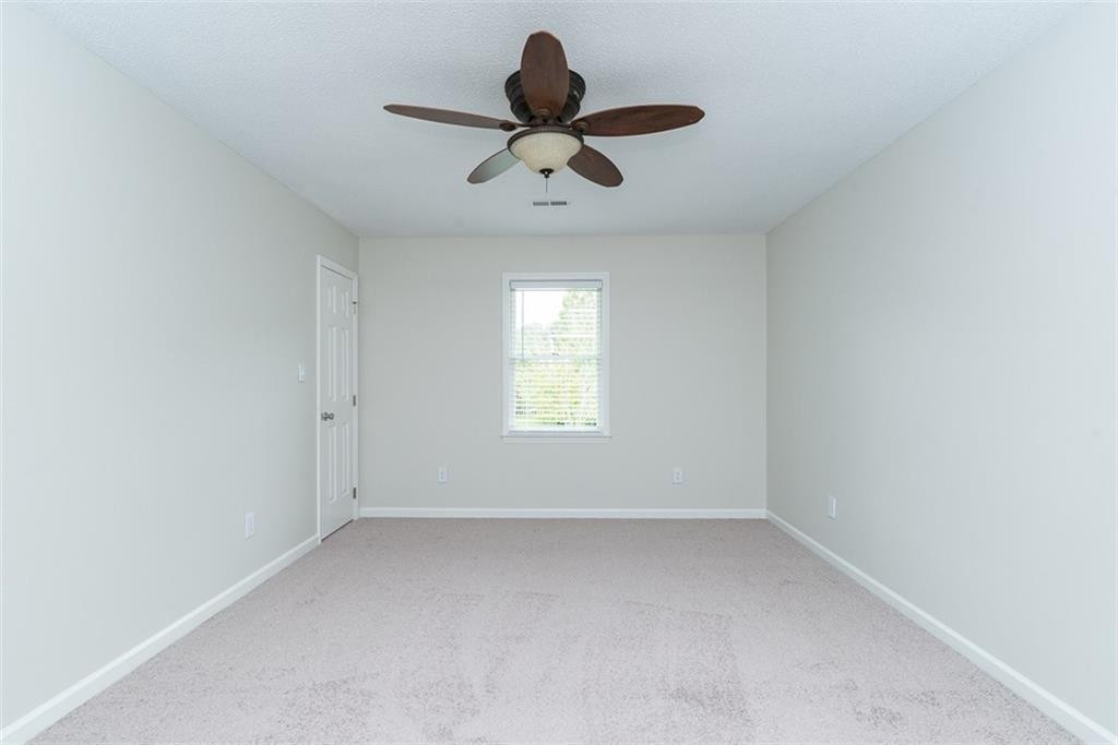 9317 Meadow Rue Place Raleigh, NC 27603 - Photo 23 of 36 a view of room with ceiling fan and window