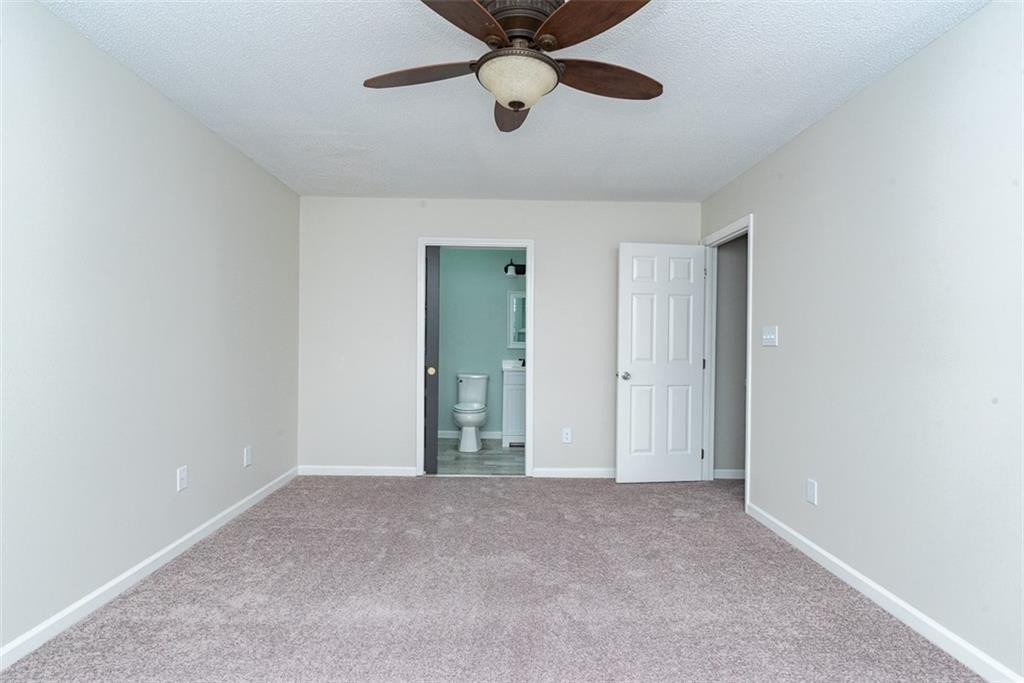 9317 Meadow Rue Place Raleigh, NC 27603 - Photo 25 of 36 a view of an empty room and chandelier fan