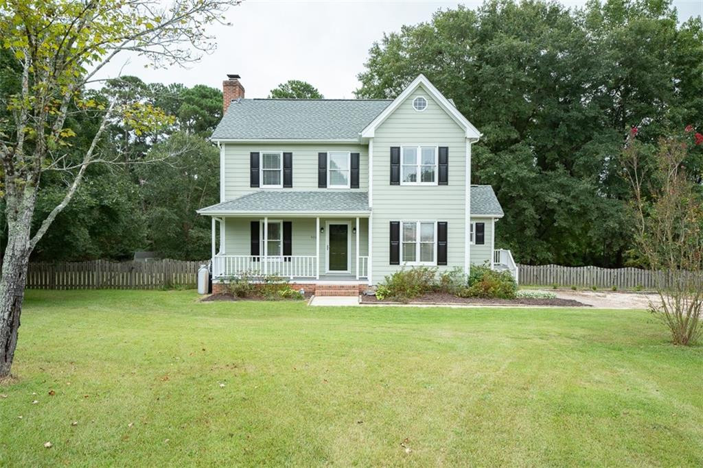 9317 Meadow Rue Place Raleigh, NC 27603 - Photo 3 of 36 a front view of a house with a garden