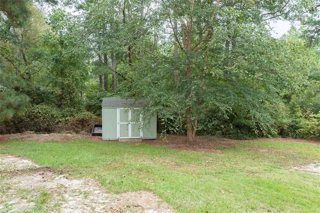 9317 Meadow Rue Place Raleigh, NC 27603 - Photo 32 of 36 a view of a backyard with large trees