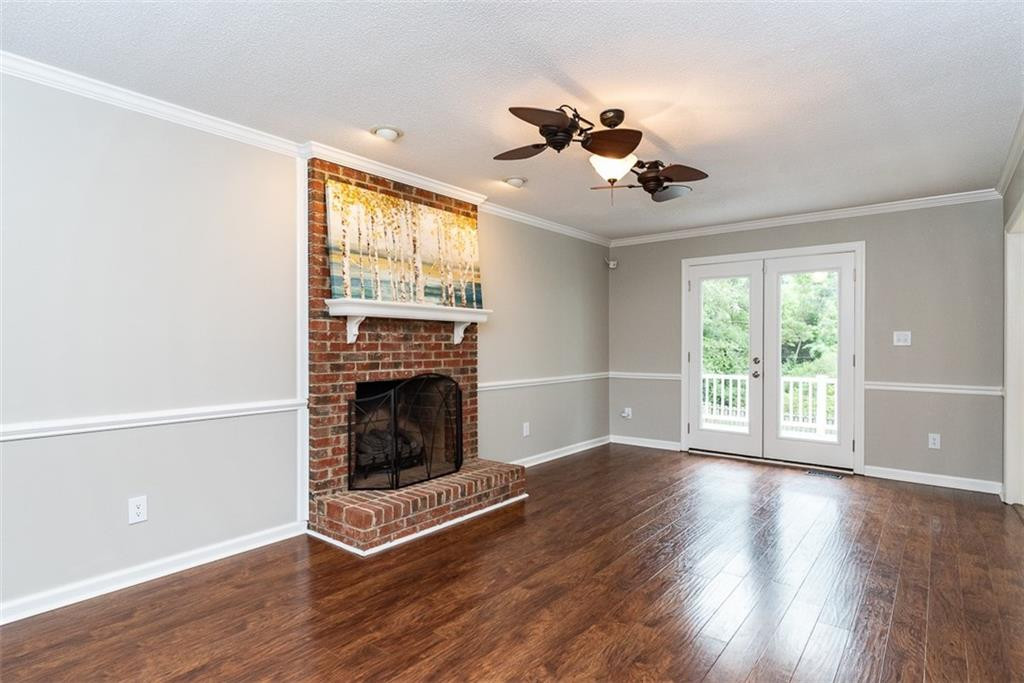 9317 Meadow Rue Place Raleigh, NC 27603 - Photo 6 of 36 a view of an empty room with wooden floor and a window