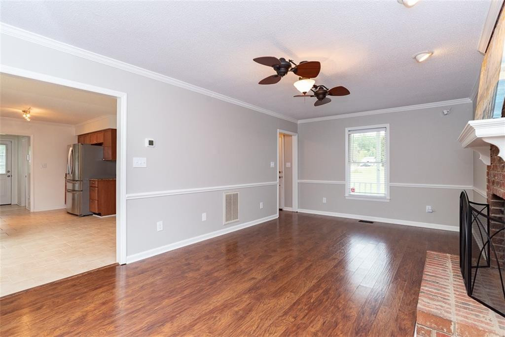 9317 Meadow Rue Place Raleigh, NC 27603 - Photo 8 of 36 a view of an empty room with wooden floor and a window