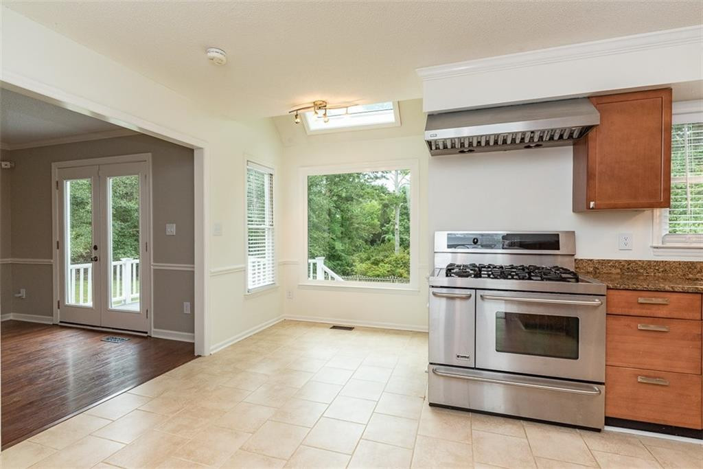 9317 Meadow Rue Place Raleigh, NC 27603 - Photo 9 of 36 a kitchen with a stove top oven and sink